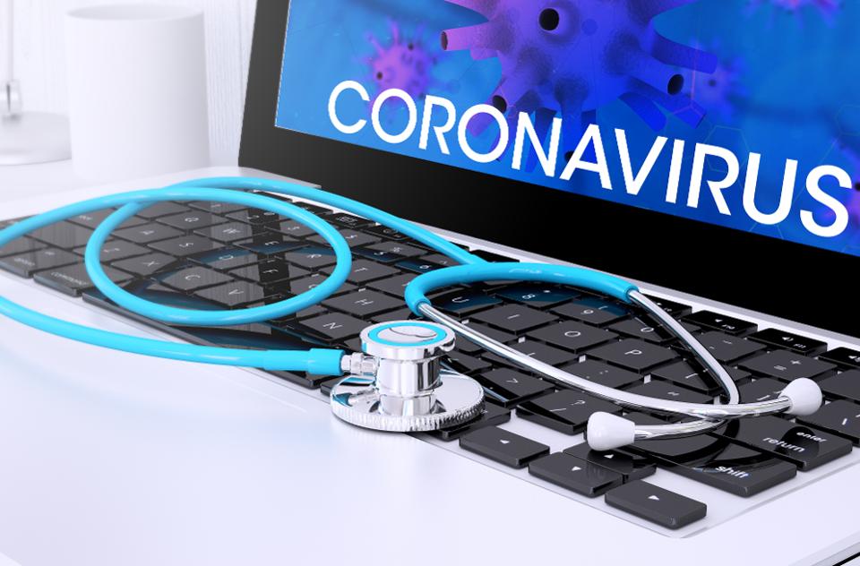 stethoscope on laptop keyboard with screen showing coronavirus