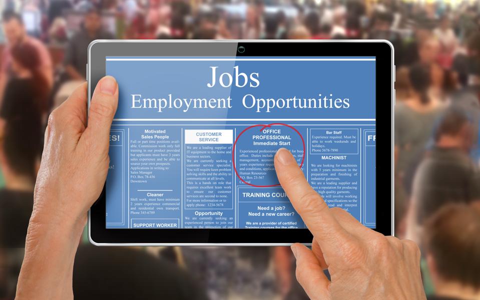 Reading online job ads on a computer tablet -